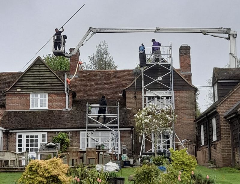 The Roof Moss Cleaners using cherry picker and scaffolding to clean roof safely and professionally in How Wood, Hertfordshire